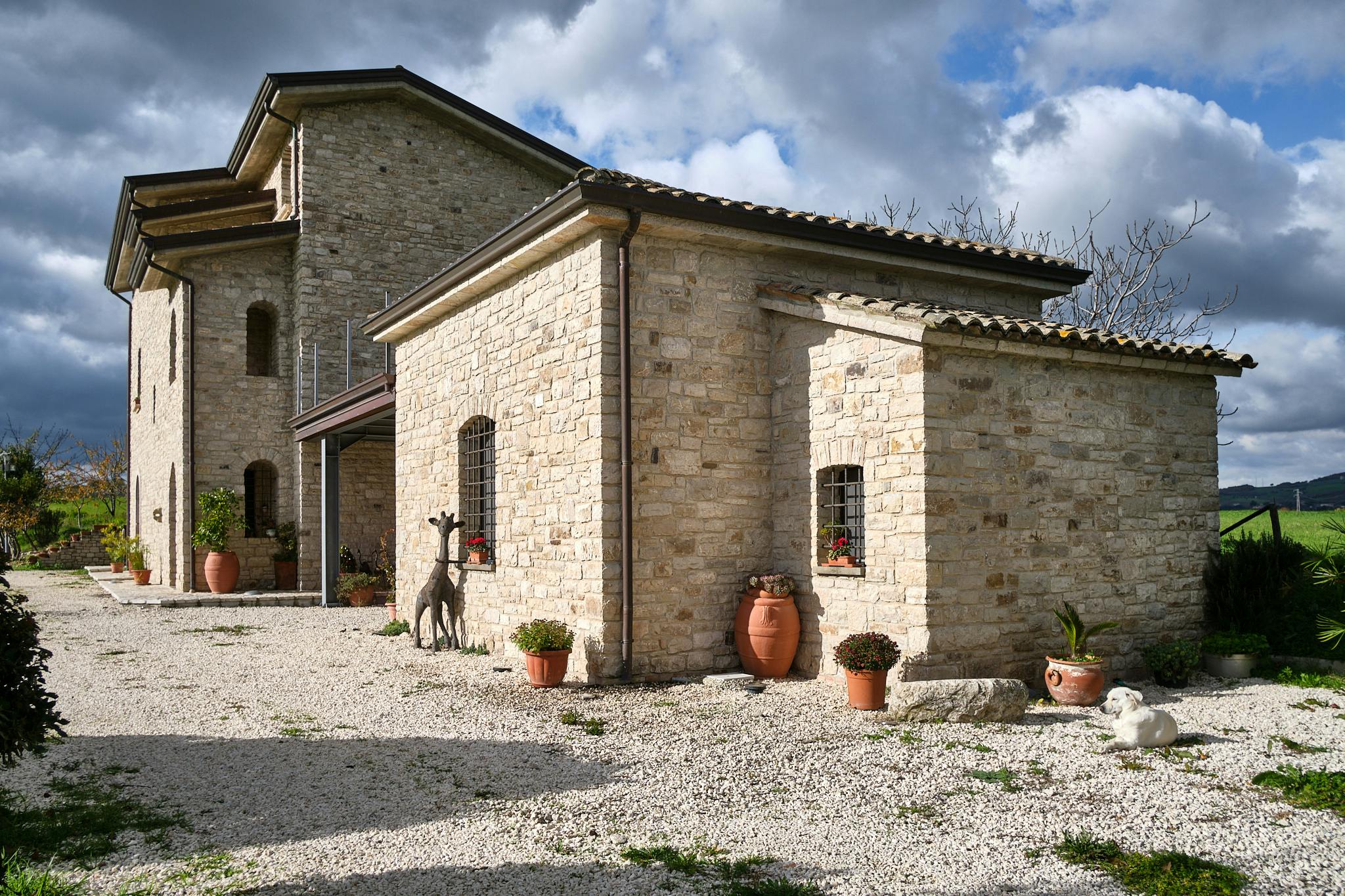 Frontal view of the Dependance of the Le Pietre estate. The structure is in stone with iron inserts. An iron giraffe watches over the entrance.